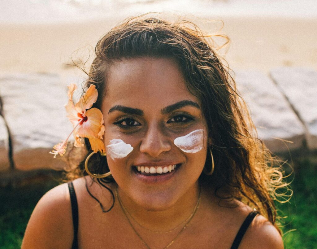 Woman in the sun with sunscreen on her face